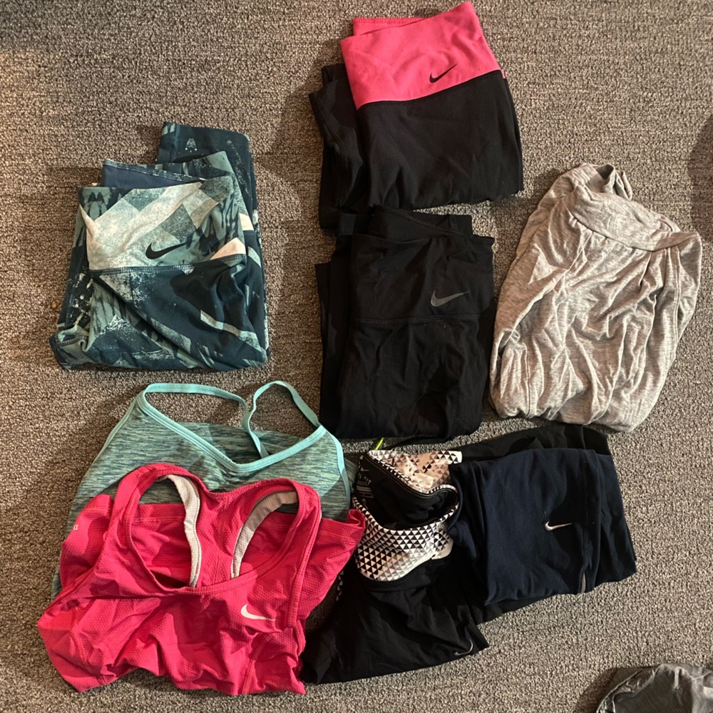 Bag of Nike gear 2 tank tops 4 long slim pants and 4 skinny leg capris